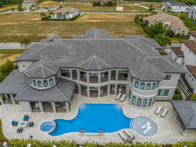 an aerial view of a house with swimming pool and outdoor space