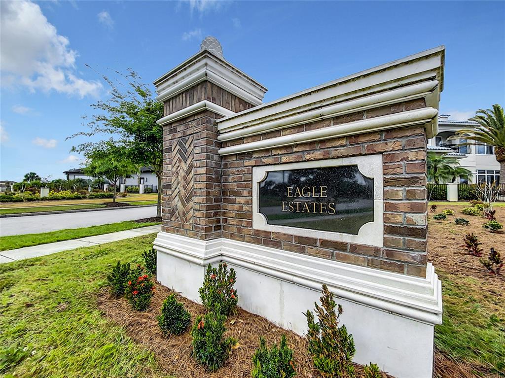 8033 Twin Eagles Loop Reunion, FL 34747 - Photo 4 of 42 a front view of a house with a garden