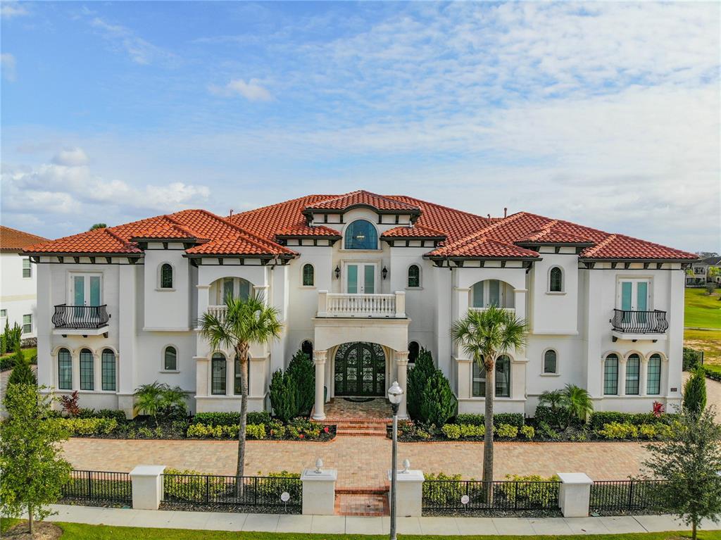 8033 Twin Eagles Loop Reunion, FL 34747 - Photo 6 of 42 a front view of a house with a garden