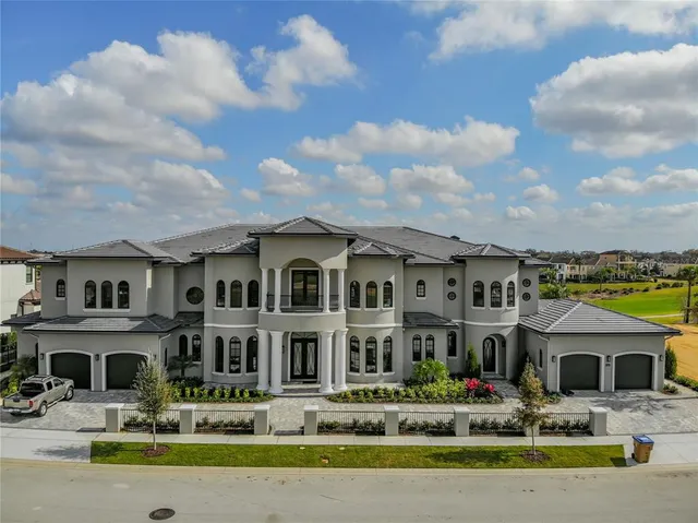 a front view of a building with a garden and plants