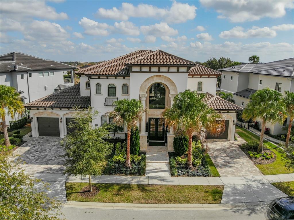 8033 Twin Eagles Loop Reunion, FL 34747 - Photo 10 of 42 a front view of a house with garden