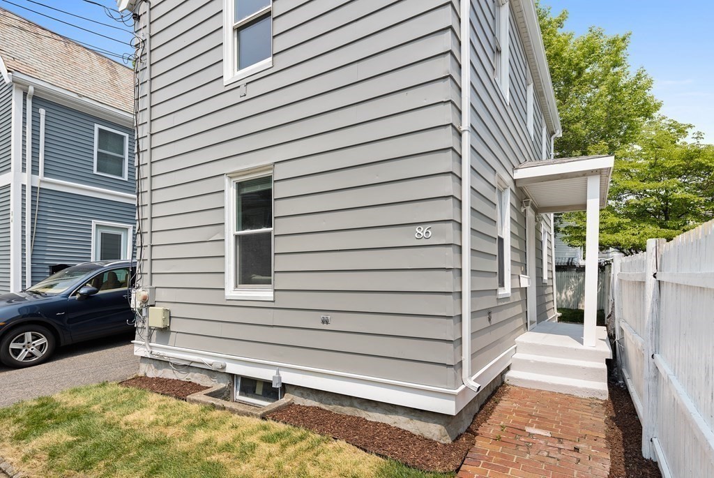 86 West Street Newton, MA 02458 - Photo 15 of 19 a view of a house with a door and wooden bench