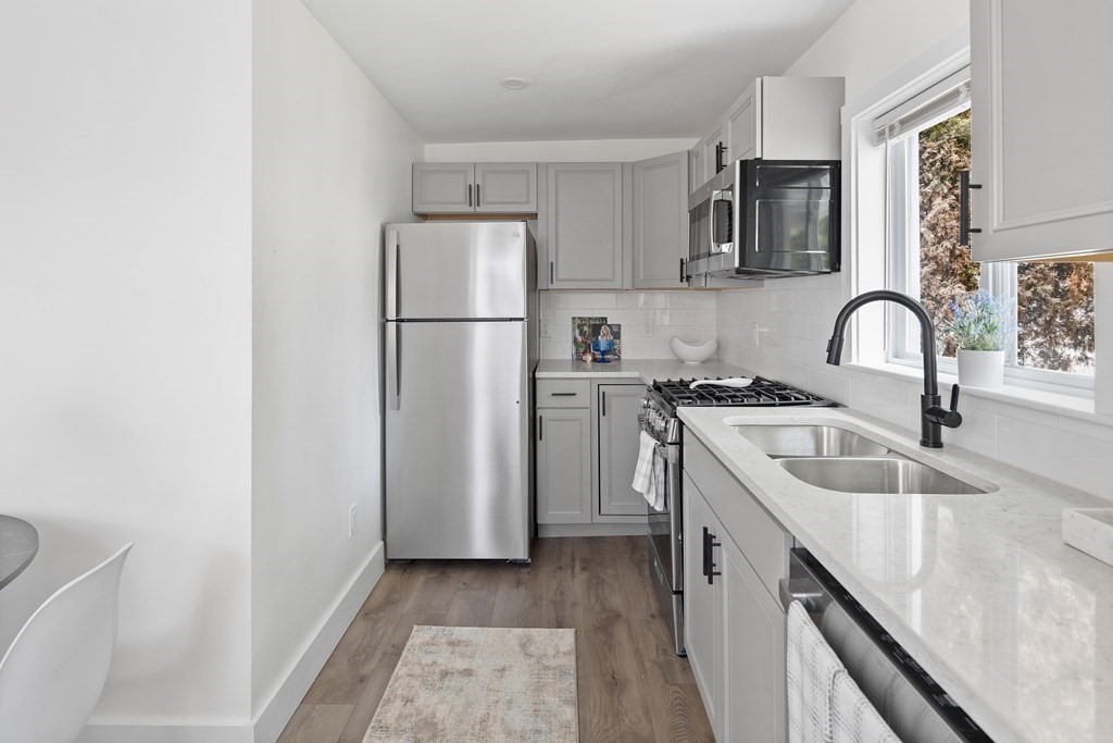 86 West Street Newton, MA 02458 - Photo 2 of 19 a kitchen with a refrigerator sink and white cabinets