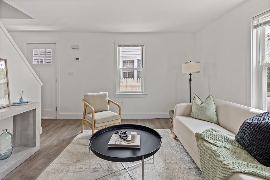 86 West Street Newton, MA 02458 - Photo 4 of 19 a living room with furniture a rug a lamp and a fireplace
