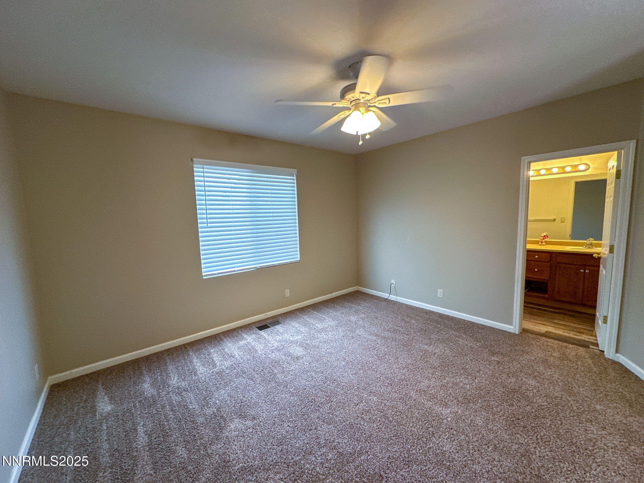 2185 Eagle Greens Drive Reno, NV 89521 - Photo 12 of 22 an empty room with windows and fan