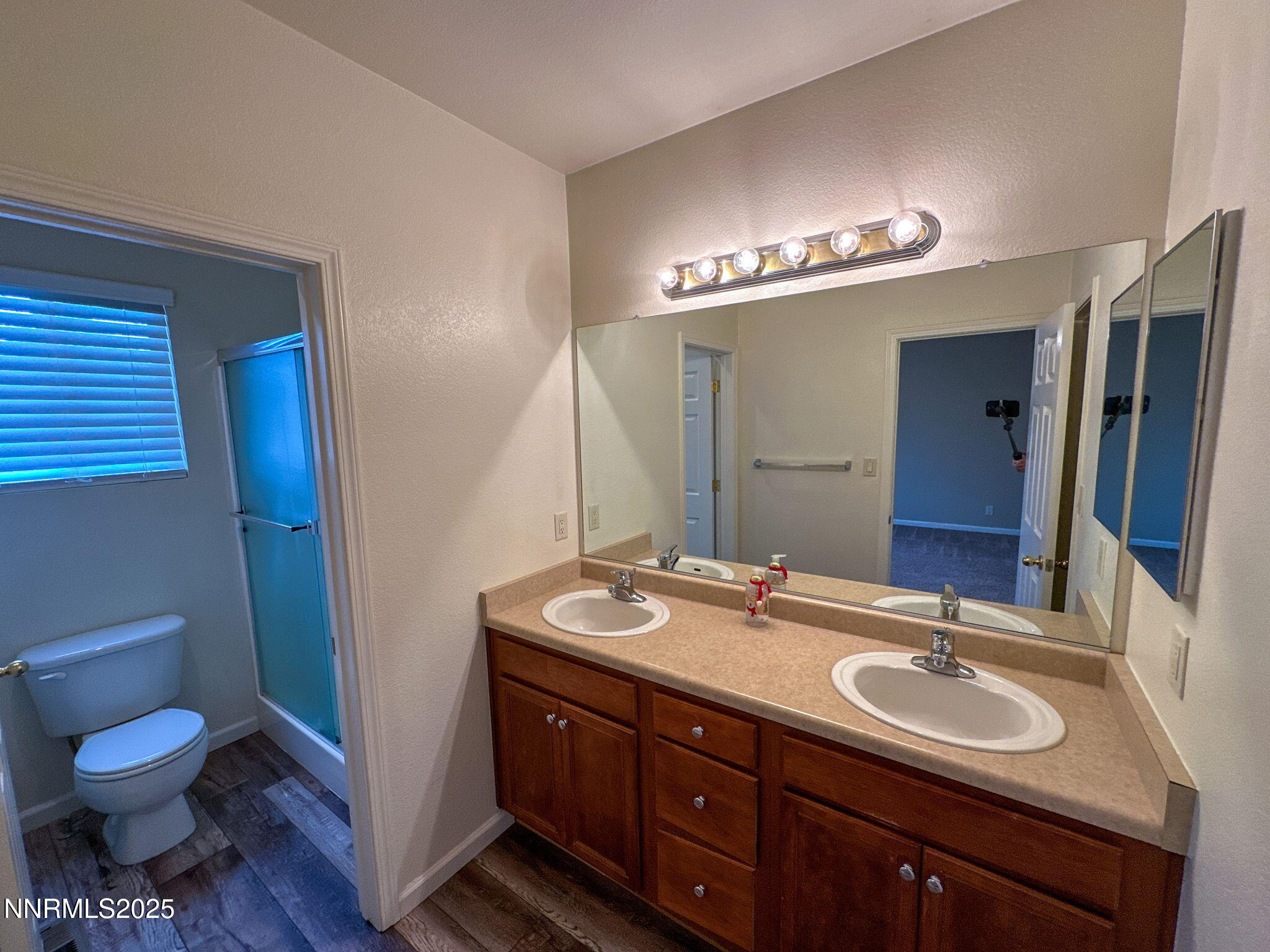 2185 Eagle Greens Drive Reno, NV 89521 - Photo 13 of 22 a bathroom with a granite countertop sink a toilet and a mirror