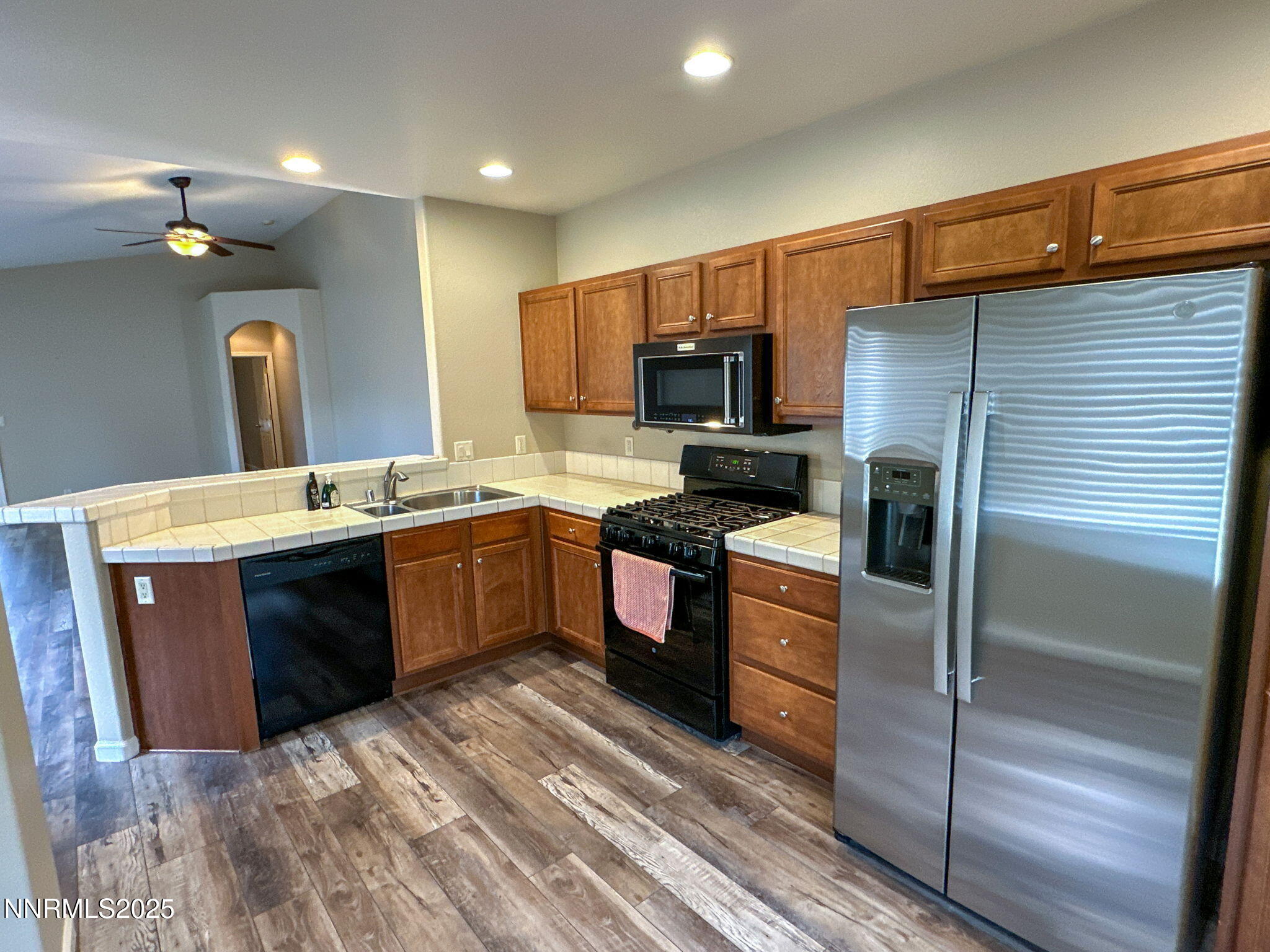 2185 Eagle Greens Drive Reno, NV 89521 - Photo 8 of 22 a kitchen with a sink stove and refrigerator