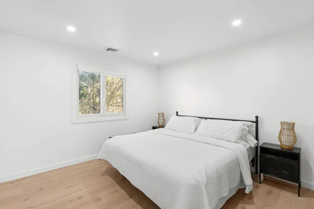 a bedroom with a bed and a night stand