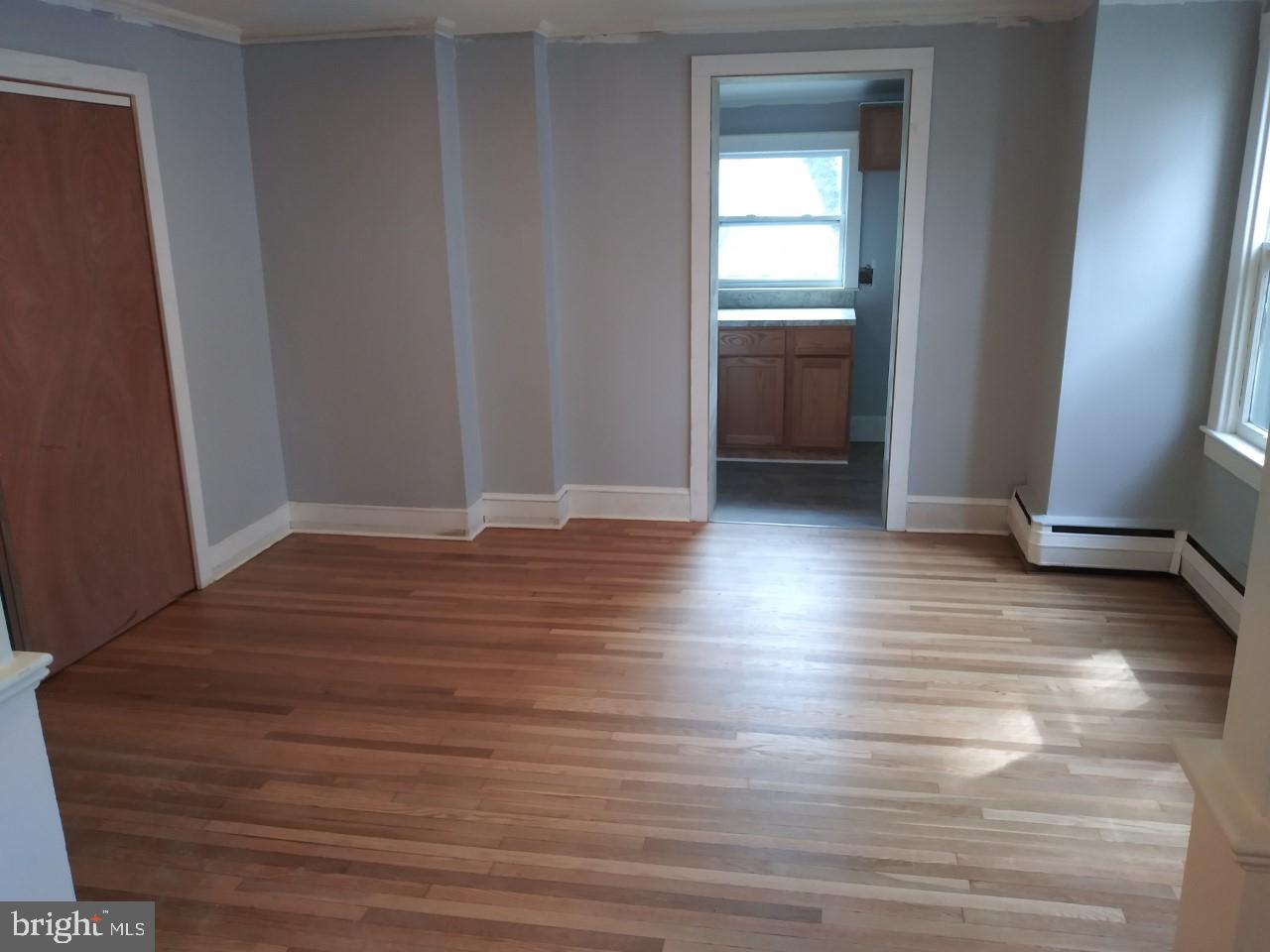 2617 Lindsay Street Chester, PA 19013 - Photo 6 of 10 a view of wooden floor and windows in a room