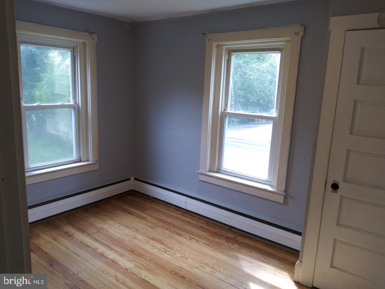 2617 Lindsay Street Chester, PA 19013 - Photo 8 of 10 a view of an empty room with wooden floor and a window