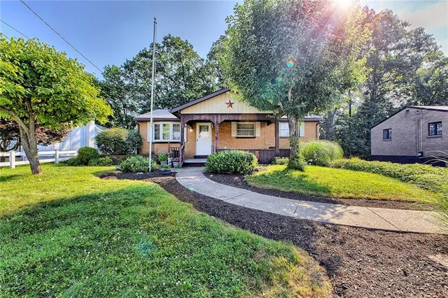 a front view of a house with garden