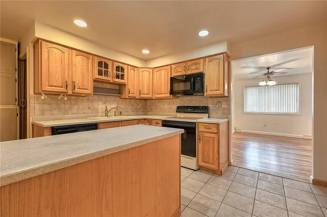 a kitchen with stainless steel appliances a refrigerator sink and microwave