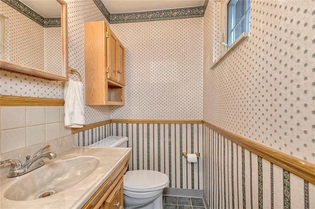 a view of a room with wooden floor and fan