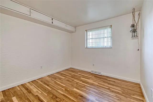 a view of a room with wooden floor