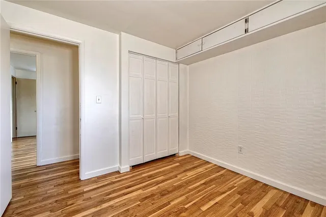 a view of a room that has a bed and a window