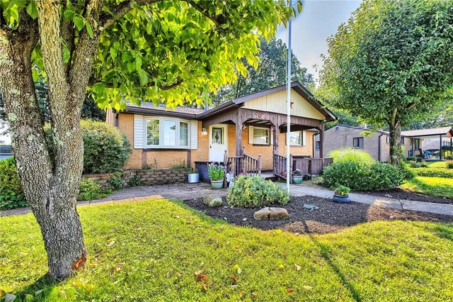 a front view of a house with a yard and porch