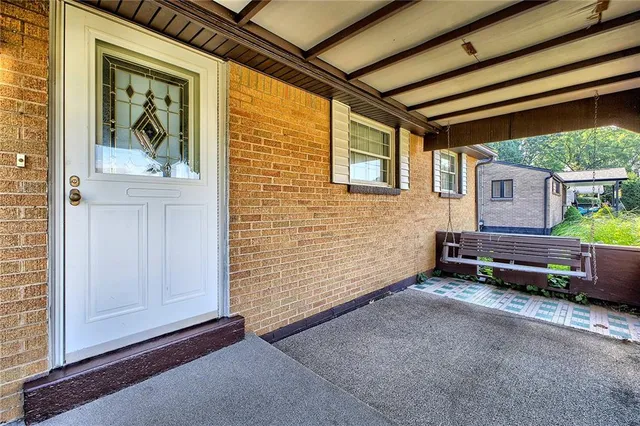a backyard of a house with barbeque oven table and chairs