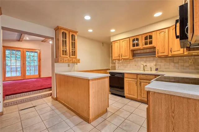 a kitchen with stainless steel appliances granite countertop a sink and cabinets