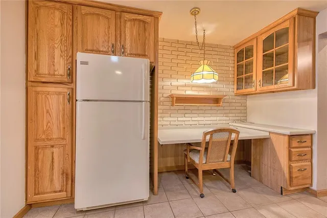 a white refrigerator freezer sitting in a kitchen