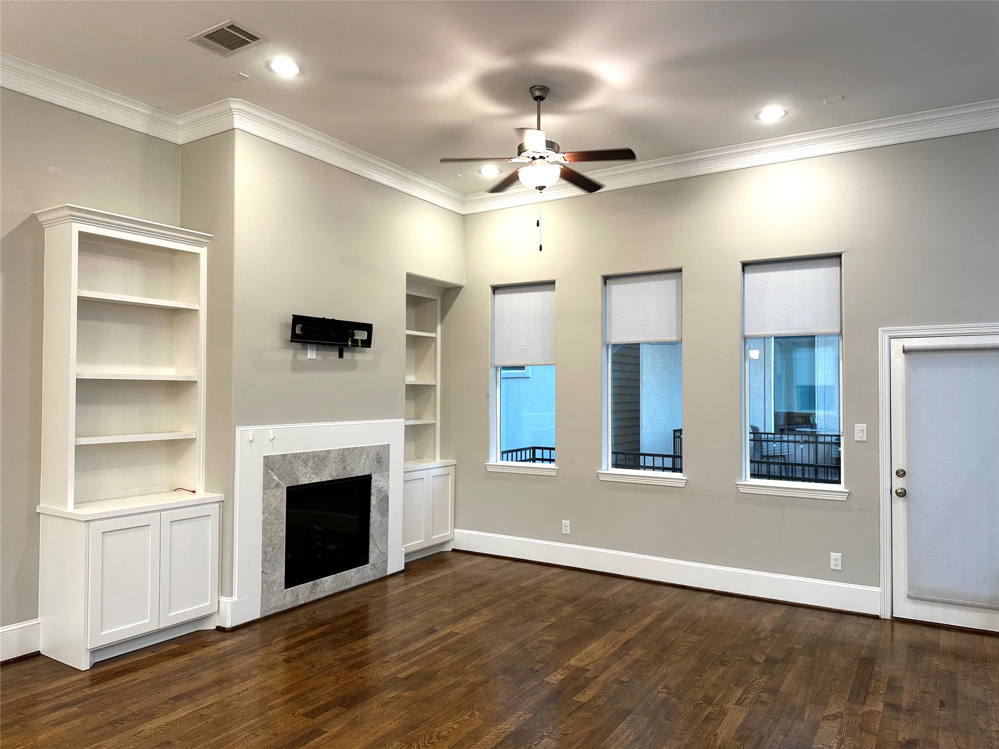 1621 Shearn Street Houston, TX 77007 - Photo 8 of 45 an empty room with wooden floor fireplace and windows