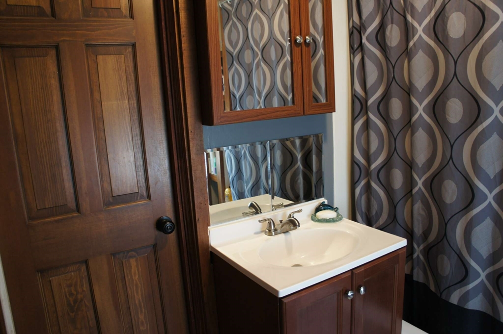 32 Birch Road Natick, MA 01760 - Photo 27 of 38 a bathroom with a sink and a mirror