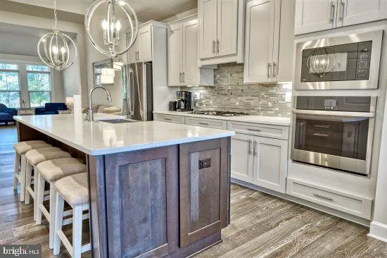 a kitchen with stainless steel appliances granite countertop a sink and cabinets