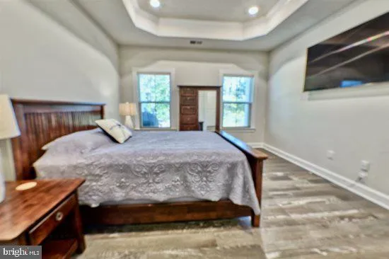 a bedroom with a bed and flat screen tv