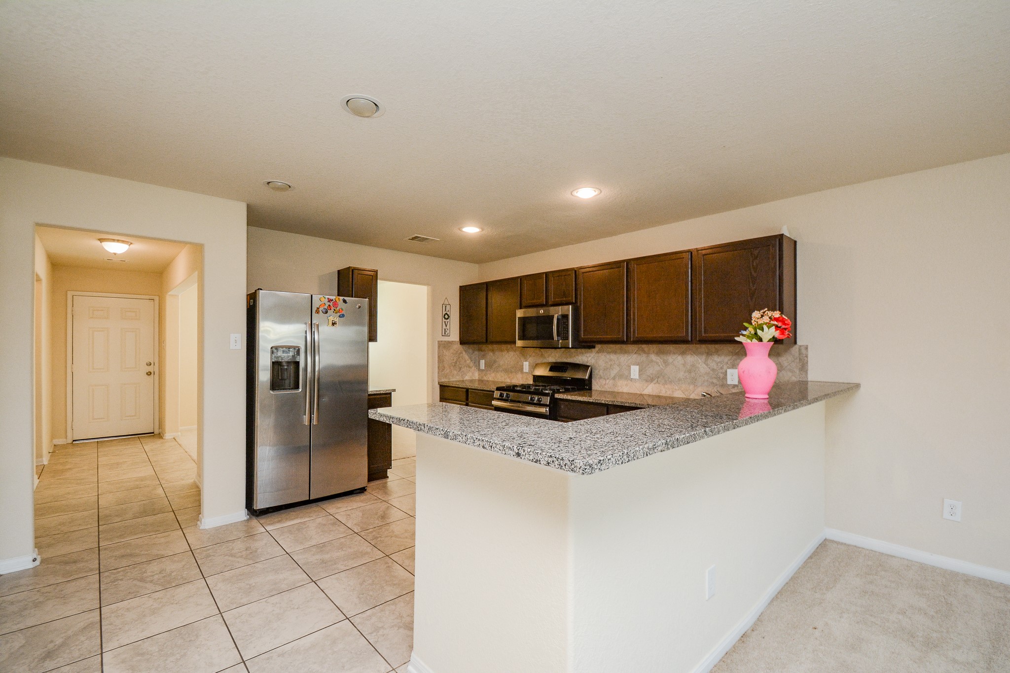 2214 Forest Court Rosenberg, TX 77471 - Photo 4 of 20 a kitchen with stainless steel appliances granite countertop a refrigerator and a sink