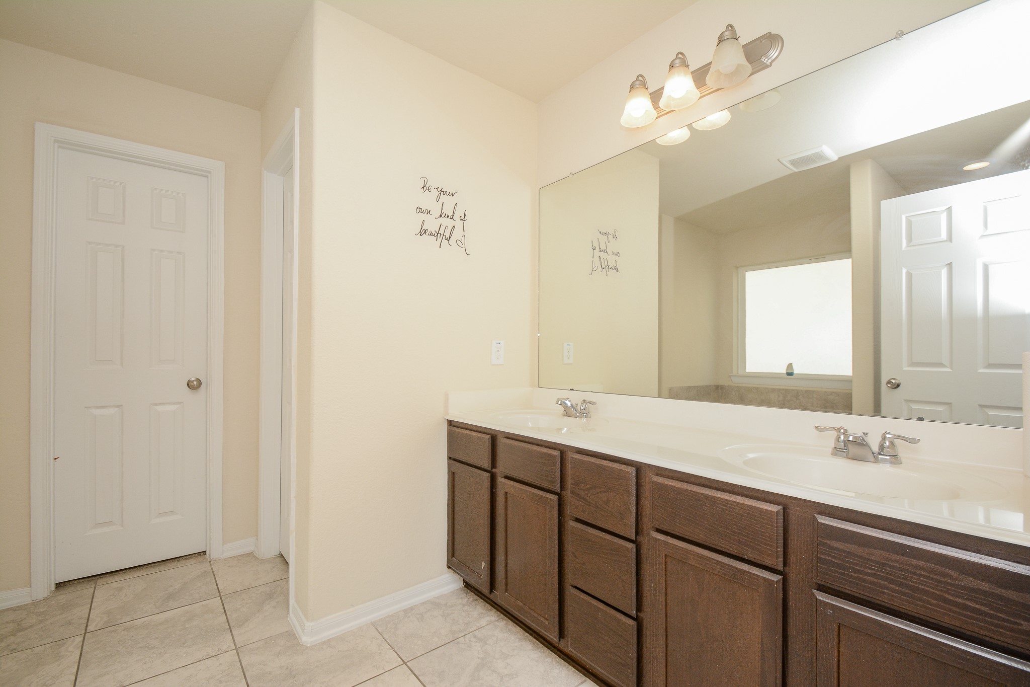 2214 Forest Court Rosenberg, TX 77471 - Photo 8 of 20 a bathroom with a double vanity sink and a mirror