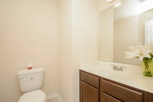 a bathroom with a sink a toilet and a mirror