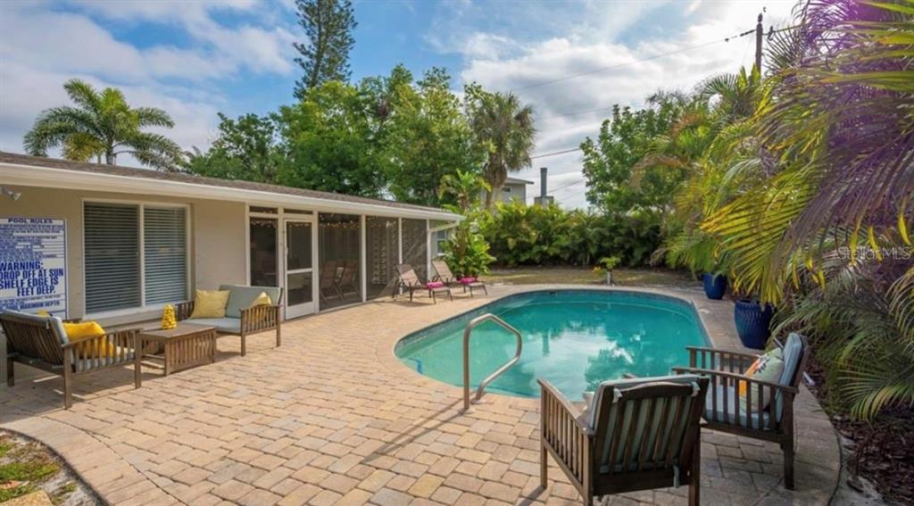 2904 Homasassa Road Sarasota, FL 34239 - Photo 11 of 37 a patio with table and chairs and potted plants