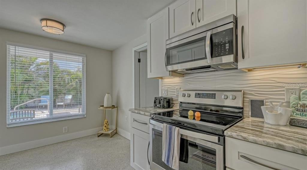 2904 Homasassa Road Sarasota, FL 34239 - Photo 14 of 37 a kitchen with a stove and a microwave
