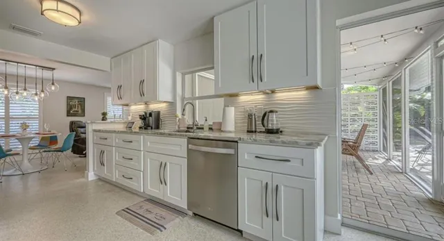 a kitchen with cabinets appliances and a window
