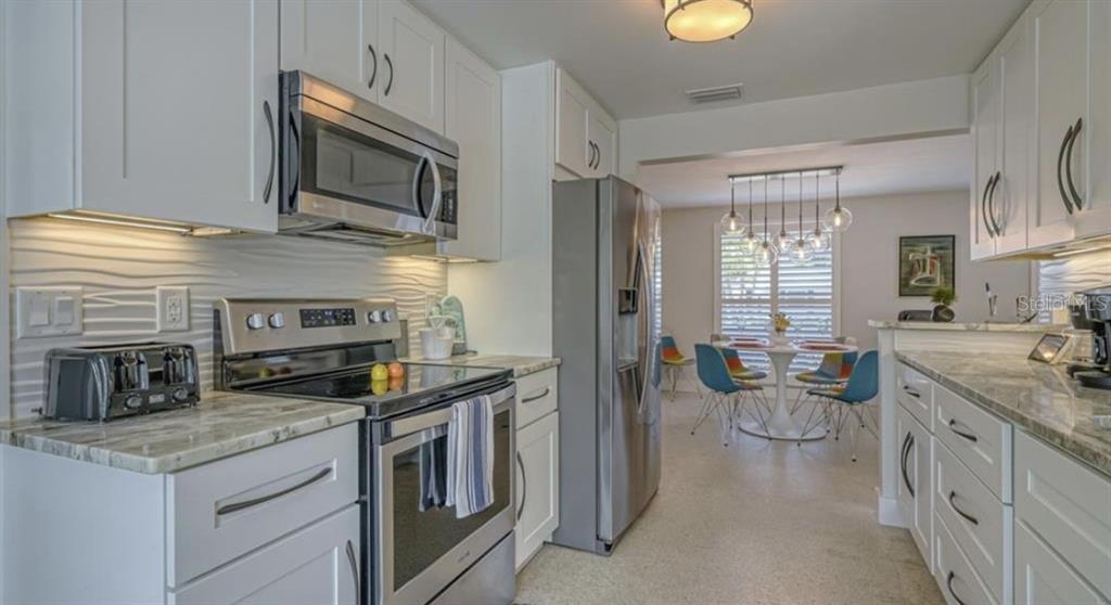 2904 Homasassa Road Sarasota, FL 34239 - Photo 16 of 37 a kitchen with a sink stove and cabinets