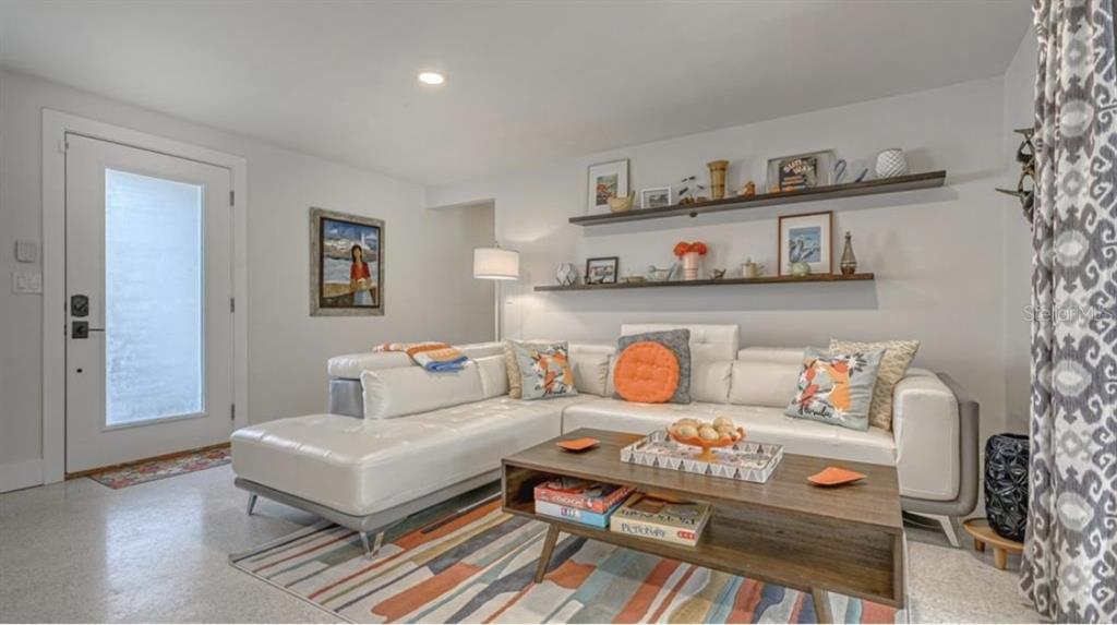 2904 Homasassa Road Sarasota, FL 34239 - Photo 4 of 37 a bedroom with furniture and a wooden floor