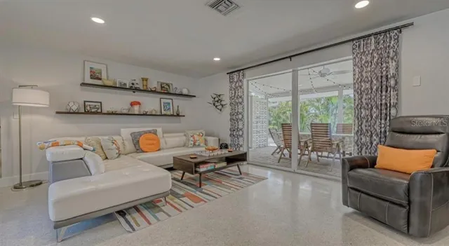 a living room with furniture and a floor to ceiling window