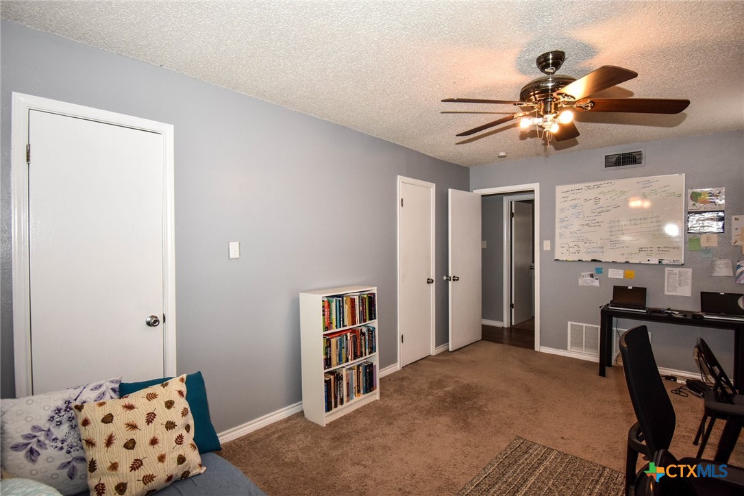 2202 Stagecoach Trail Temple, TX 76502 - Photo 11 of 27 a bedroom with a bed and a chandelier