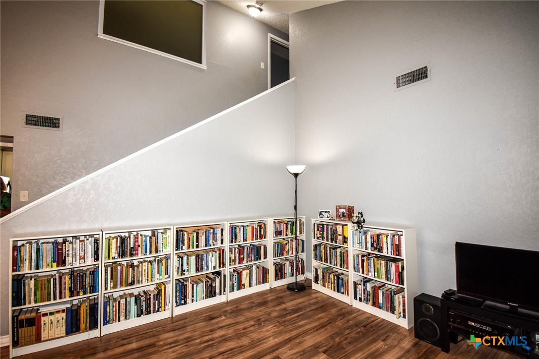 2202 Stagecoach Trail Temple, TX 76502 - Photo 22 of 27 a living room with lots of books and a view of living room