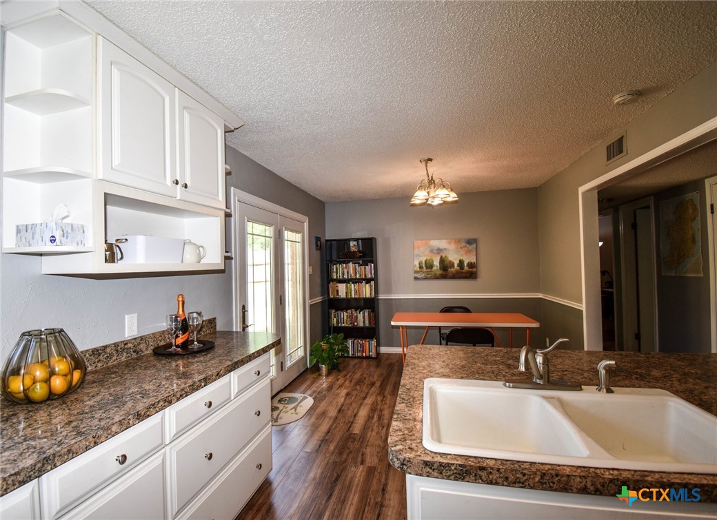 2202 Stagecoach Trail Temple, TX 76502 - Photo 8 of 27 a kitchen with granite countertop a sink and cabinets