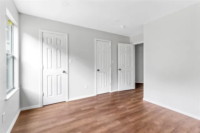 a view of kitchen with wooden floor and electronic appliances