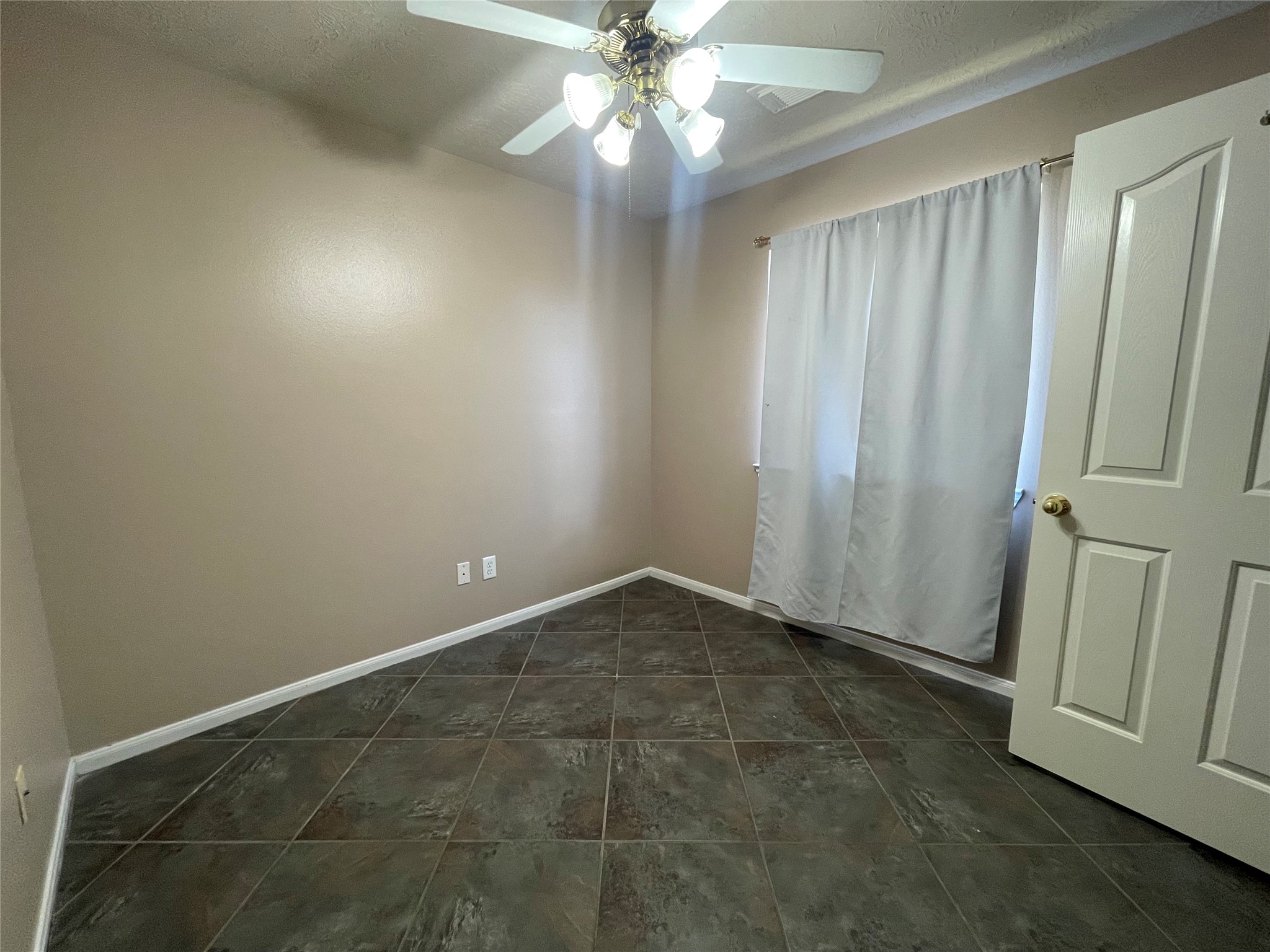 22911 Sebastian Drive Porter, TX 77365 - Photo 15 of 23 an empty room with a ceiling fan and window