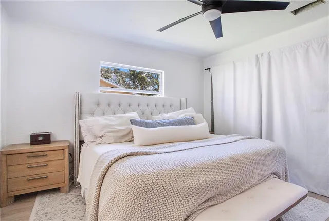 a bedroom with a bed and a window