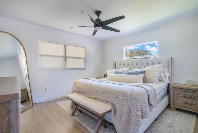 a bedroom with a bed and a window