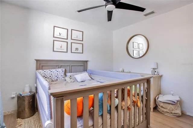 a bedroom with a bed and a chandelier