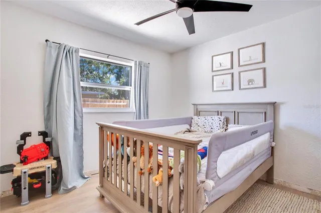 a bedroom with furniture and a baby crib