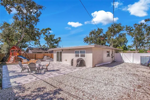 a view of a chair and table in the backyard