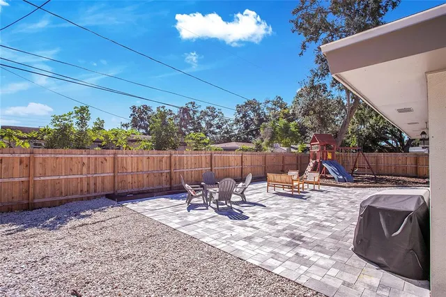 a view of a backyard with sitting area