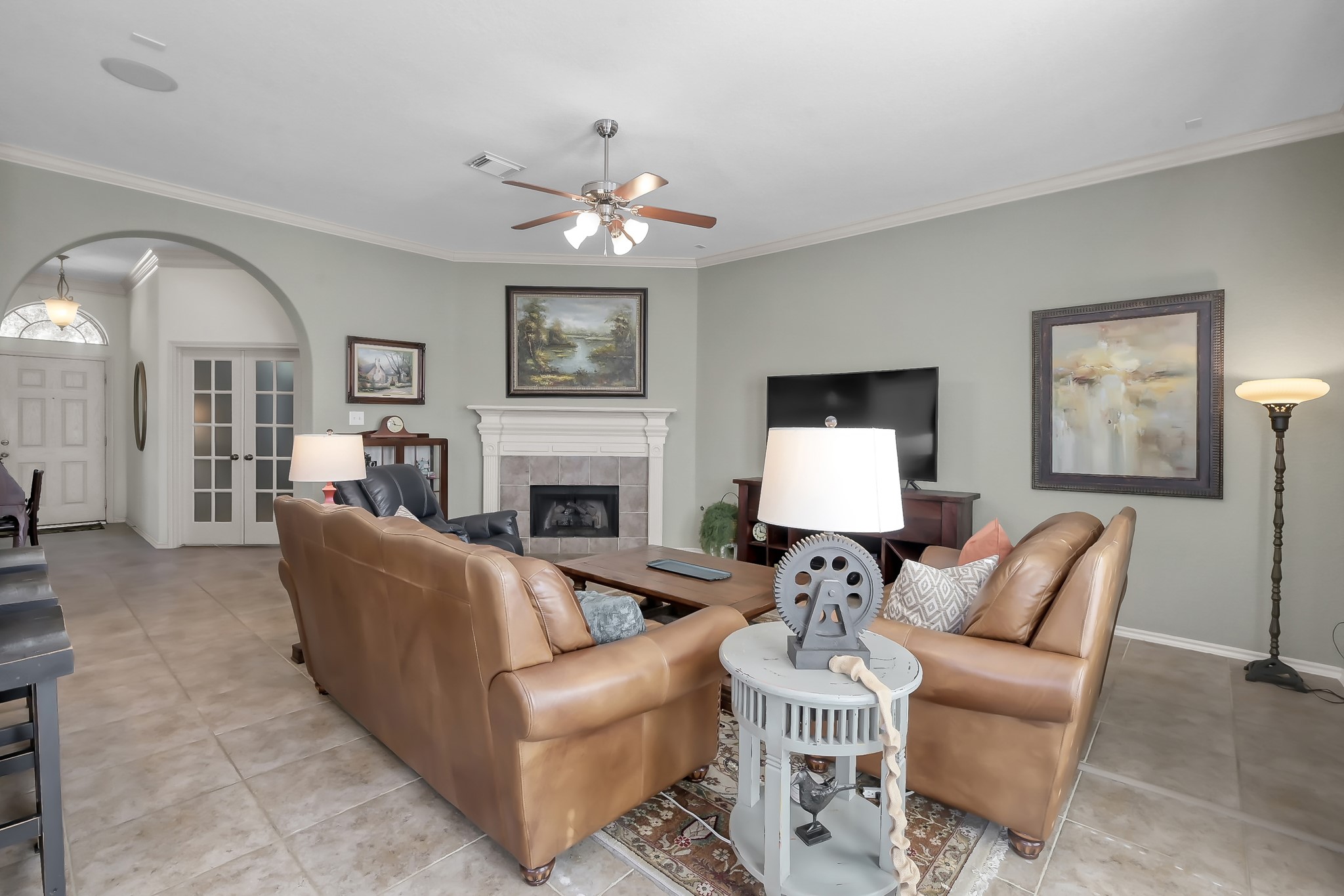 2318 Caroline Park Lane Spring, TX 77386 - Photo 12 of 38 a living room with furniture a fireplace and a chandelier