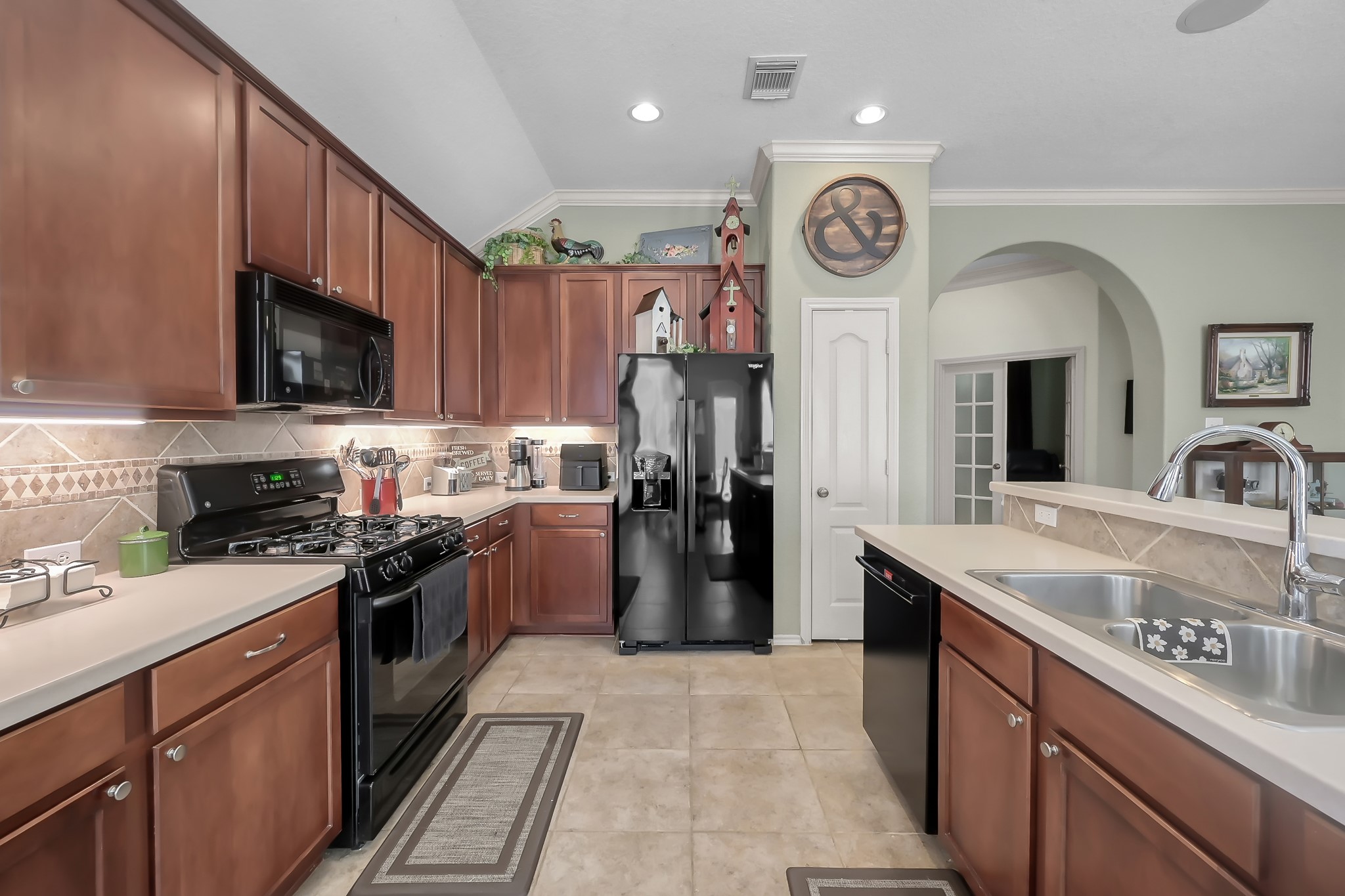 2318 Caroline Park Lane Spring, TX 77386 - Photo 17 of 38 a kitchen with a sink a stove top oven and refrigerator