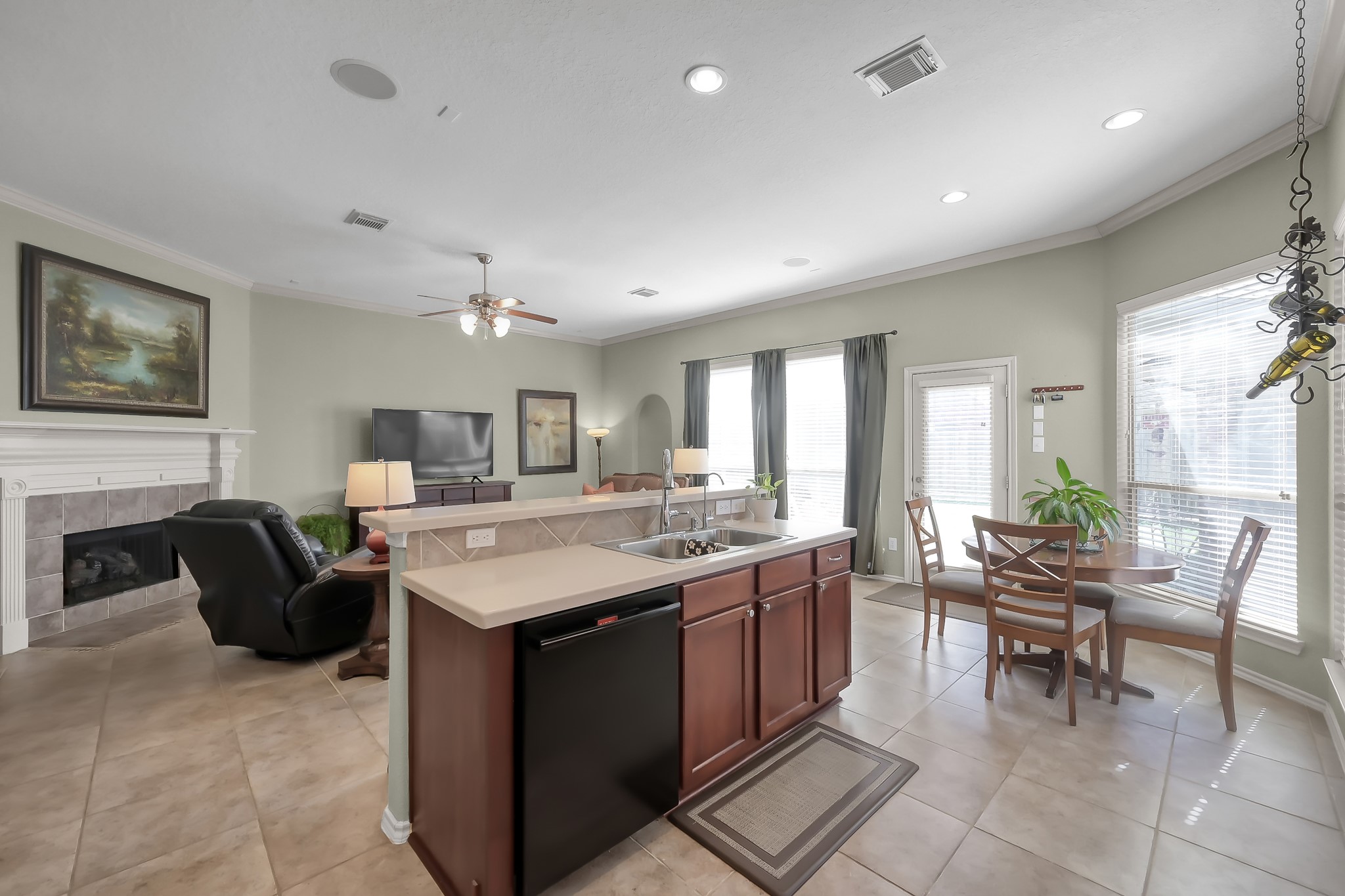 2318 Caroline Park Lane Spring, TX 77386 - Photo 19 of 38 a large living room with stainless steel appliances granite countertop furniture a fireplace and a large window